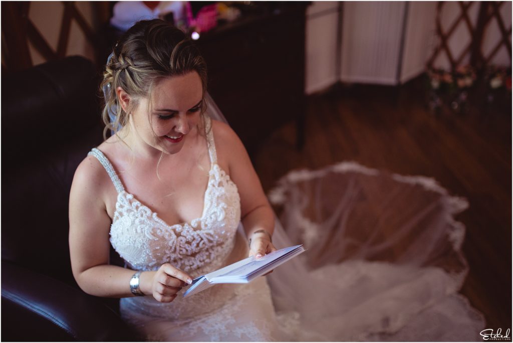 bride reading card seated in a chair